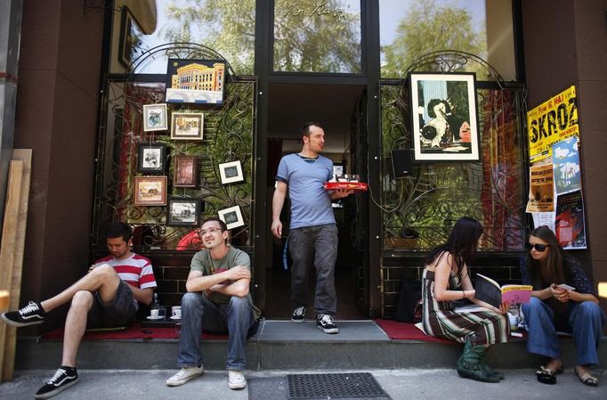 Almin Dzafic, a 30 year-old waiter, poses for a picture as he serves customers in the Galerija Boris Smoje cafe in Sarajevo, May 11, 2012. Dzafic studied for four years at Sarajevo University where he received a degree in civil engineering. For the last four years he has tried to find a job in art restoration but has been working as a waiter for two years. He sees his future outside of Bosnia and Herzegovina because he can not find a job.