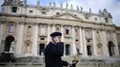 A priest chats on his phone as he watches workers put up a red curtain on the central balcony, called the Loggia of the Blessings of Saint Peter's Basilica at the Vatican March 11, 2013. After being elected in the conclave the new pope will appear on the balcony. REUTERS/Dylan Martinez (VATICAN - Tags: RELIGION) Published: Bře. 11, 2013, 10:20 dop.