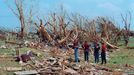 A Family Surveys the Destruction of Their Home and Property Original caption:Houses, property and trees in Moore, Oklahoma were devastated by an F5 tornado on May 3, 1999. An estimated 1,500 homes were destroyed. It was the first time the Oklahoma City metro area was hit by an F5 twister. An F5 is the highest level tornado on the Fujita Scale, with winds between 261-318 miles and hour. The wind was so violent it stripped the bark off of trees.