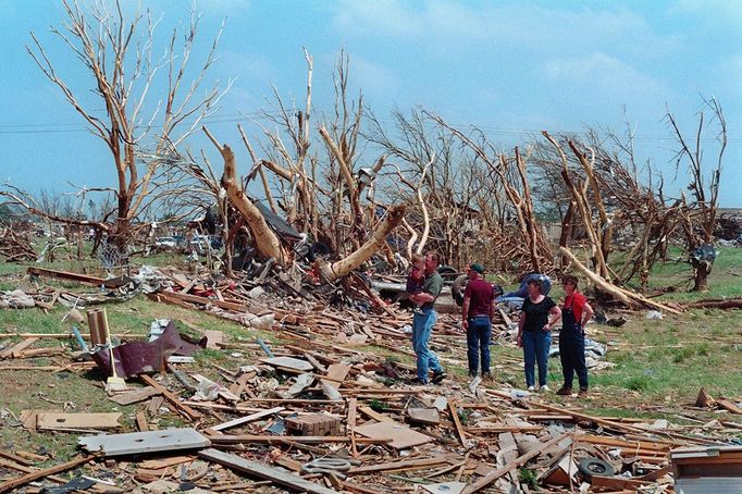 A Family Surveys the Destruction of Their Home and Property Original caption:Houses, property and trees in Moore, Oklahoma were devastated by an F5 tornado on May 3, 1999. An estimated 1,500 homes were destroyed. It was the first time the Oklahoma City metro area was hit by an F5 twister. An F5 is the highest level tornado on the Fujita Scale, with winds between 261-318 miles and hour. The wind was so violent it stripped the bark off of trees.