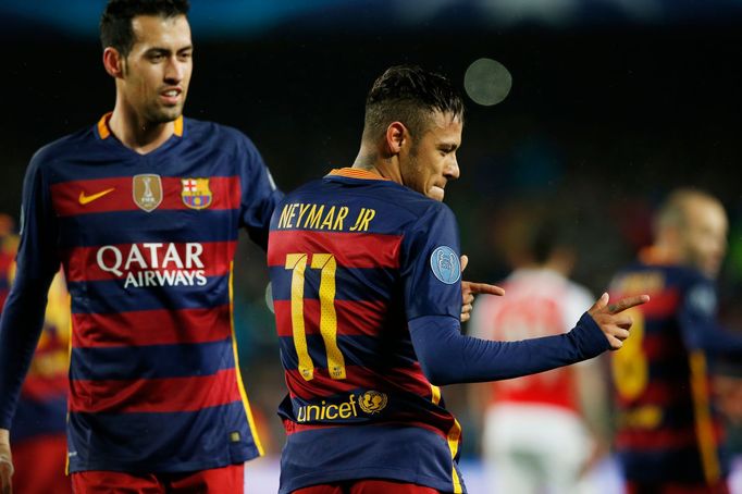 Neymar celebrates scoring the first goal for Barcelona with Sergio Busquets