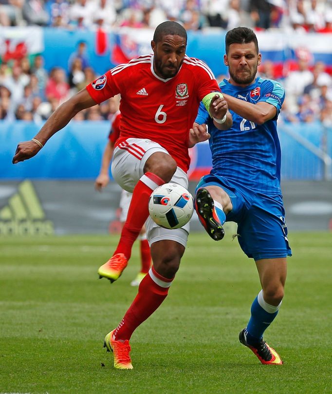 Wales' Ashley Williams in action with Slovakia's Michal Duris