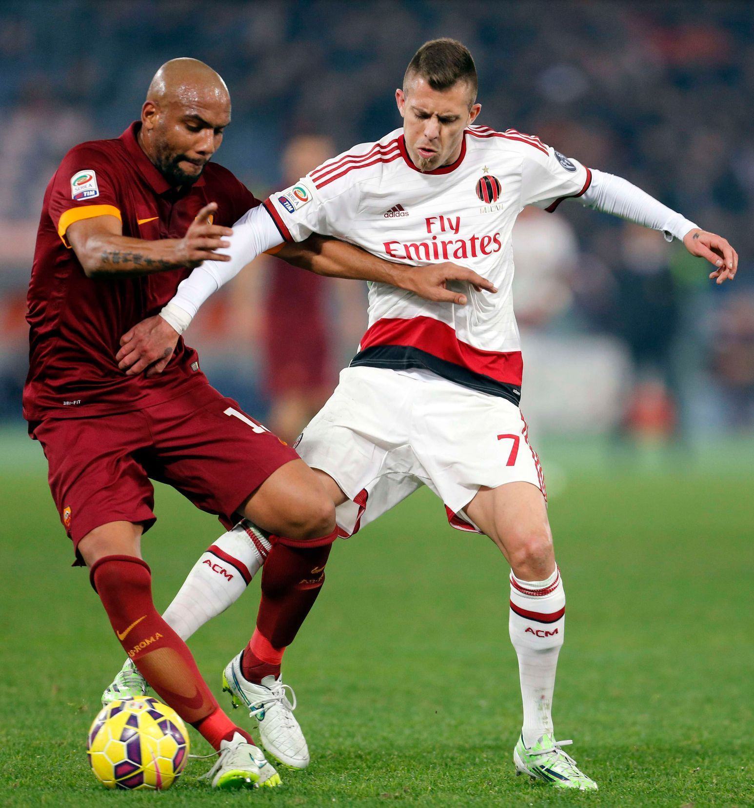 AS Roma's Maicon challenges AC Milan's Menez during their Italian Serie A soccer match in Rome