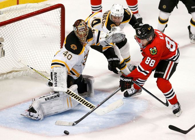 Chicago Blackhawks' Patrick Kane (88) loses control of the puck while attempting a shot on Boston Bruins goalie Tuukka Rask as Bruins' Dennis Seidenberg (44) defends duri