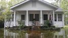 Keith Haydel and his dog Jazz wait on their front porch for flood water to recede after Hurricane Isaac hit Mandeville, Louisiana, August 30, 2012. REUTERS/Jonathan Bachman (UNITED STATES - Tags: ENVIRONMENT DISASTER) Published: Srp. 30, 2012, 7:38 odp.