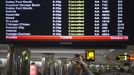 A traveller takes pictures of a flight monitor showing cancelled flights at LaGuardia airport in New York October 28, 2012. Tens of millions of East Coast residents scrambled on Sunday to prepare for Hurricane Sandy, which could make landfall as the largest storm to hit the United States, bringing battering winds, flooding and even heavy snow. REUTERS/Adrees Latif (UNITED STATES - Tags: TRANSPORT DISASTER ENVIRONMENT)