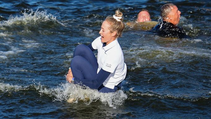 Apr 21, 2024; The Woodlands, Texas, USA; Nelly Korda (USA) jumps in the 18th ward hazard after winning The Chevron Championship golf tournament. Mandatory Credit: Thomas