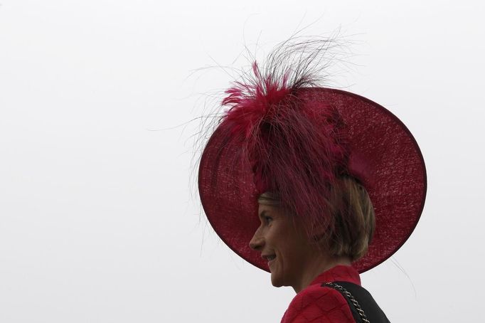 A woman poses in her hat on Ladies Day, the second day of racing at the Cheltenham Festival horse racing meet in Gloucestershire, western England March 14.