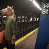 A participant in the Village Halloween Parade waits to ride the subway after the parade in the Manhattan borough of New York