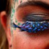 A festival goer displays her false eyelashes at Worthy Farm in Somerset, on the second day of the Glastonbury music festival