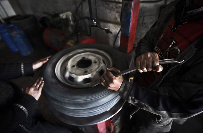 Gaza child labour 2012-02-23 00:00:00 epa03119004 Palestinian children work repairing a car tyre in the town of Beit Lahyia in northern Gaza on 23 February 2012. Reports state that child labor is widespread in the Gaza Strip because of the high rate of poverty and unemployment. Palestinain children leave school and go to work in an attempt to improve their standard of living, for low salaries because of lack of employment opportunities in Gaza. EPA/ALI ALI