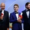 Director Xavier Dolan poses on stage next to French producer Alain Sarde and actor Daniel Bruhl after being awarded with Jury Prize award for his film &quot;Mommy&quot; during the closing ceremony of