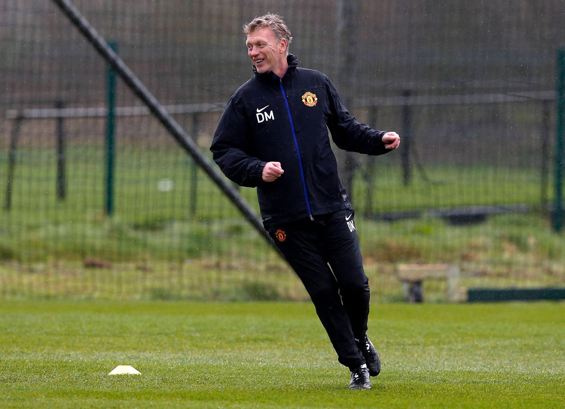 Manchester United's manager Moyes smiles during a training session at the club's Carrington training complex in Manchester