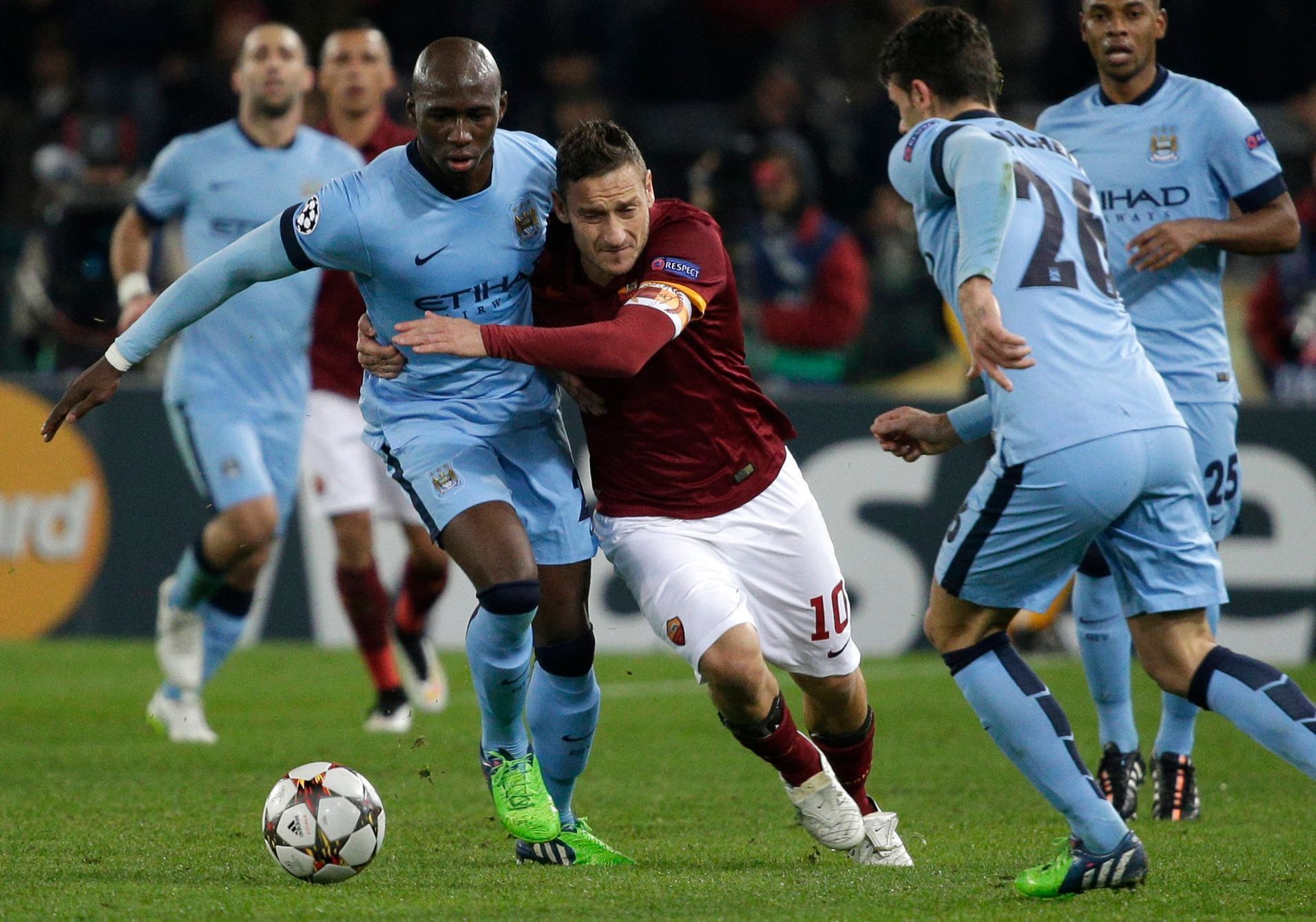 AS Roma's Francesco Totti is challenged by Manchester City's Eliaquim Mangala (L) during their Champions League Group E soccer match in Rome