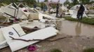 Residents survey the damage to their homes in a camp for displaced people in a low lying area of Port-Au-Prince, August 25, 2012. Tropical Storm Isaac emerged over warm Caribbean waters on Saturday slightly weaker but ready to regroup after dumping torrential rains on Haiti, where thousands of people remain homeless more than two years after a devastating earthquake. REUTERS/UN/MINUSTAH/Logan Abassi/Handout (HAITI - Tags: DISASTER ENVIRONMENT) FOR EDITORIAL USE ONLY. NOT FOR SALE FOR MARKETING OR ADVERTISING CAMPAIGNS. THIS IMAGE HAS BEEN SUPPLIED BY A THIRD PARTY. IT IS DISTRIBUTED, EXACTLY AS RECEIVED BY REUTERS, AS A SERVICE TO CLIENTS Published: Srp. 25, 2012, 4:13 odp.