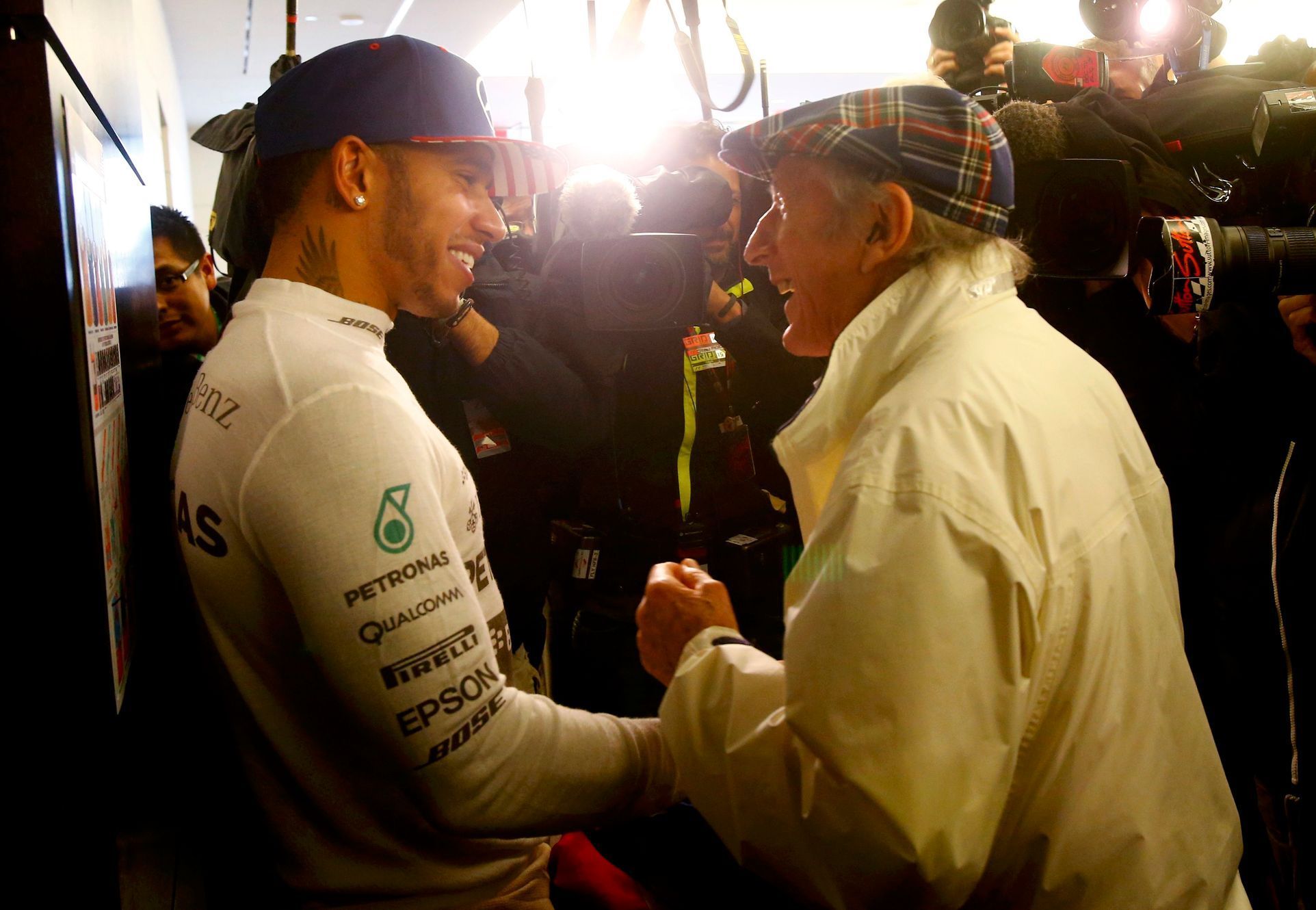 Mercedes Formula One driver Hamilton of Britain chats with three time retired world champion Stewart of Britain after Hamilton won the U.S. F1 Grand Prix at the Circuit of The Americas in Austin