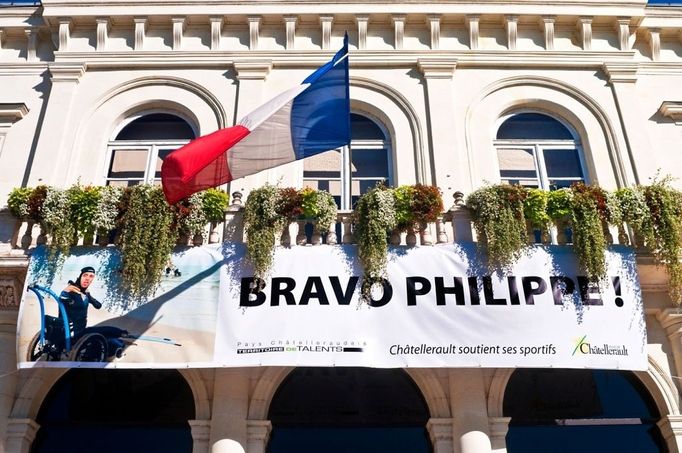 Town Hall / "Hotel de Ville" administration building, with Philippe Croizon / disabled sportsman banner - France. Philippe Croizon (born 1968) is a French athlete and the first quadruple amputee to swim across the English Channel. His amputations were required due to a severe electric shock accident which occurred in March 1994. In April 2012, Croizon announced a project to swim the four straits separating the five continents, in which he would be accompanied by long-distance swimmer Arnaud Chassery. The planned trips included Australia to Asia; across the Red Sea (linking Asia and Africa); the Straits of Gibraltar (linking Africa and Europe); and the Bering Strait (linking Asia and America).