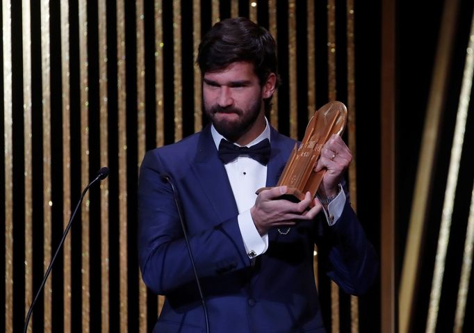 Soccer Football - The Ballon d’Or awards - Theatre du Chatelet, Paris, France - December 2, 2019  Liverpool's Alisson Becker with the Yachine Trophy  REUTERS/Christian Ha