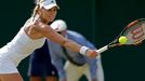 Kristina Mladenovic of France hits a shot during her match against Victoria Azarenka of Belarus at the Wimbledon Tennis Championships in London