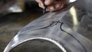 Blacksmith Johann Schmidberger works on a harness for the Vatican Swiss Guard at his workshop in Molln, Upper Austria June 12, 2012. Blacksmith brothers Johann, 29, and Georg, 28, produce made-to-order handmade harnesses for the Vatican, which take 120 hours of handiwork per piece and hardly differs from the 500-year-old originals. The brothers carry on the tradition of the blacksmith trade in the fifth generation of their family. REUTERS/Lisi Niesner (AUSTRIA - Tags: SOCIETY MILITARY) Published: Čer. 12, 2012, 10:17 odp.