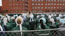 In this photo taken Aug. 22, 2012 imprisoned women stand during a morning inspection at a women's prison in a town of Sarapul, central Russia. Two members of the punk band Pussy Riot will serve their sentence in a penal colony far from Moscow that is like what a former inmate describes as a "nasty Girl Scout camp.? Although Russia?s prison system is a far cry from Stalin?s gulag, the principle remains the same: to isolate people from their families and wear them down through ?corrective labor,? which for women usually means hunching over a sewing machine. Maria Alyokhina and Nadezhda Tolokonnikova will have to quickly learn the inner laws of prison life, survive the dire food and medical care, and risk reprisal from inmates either offended by their "punk prayer" against President Vladimir Putin or ordered to pressure them by higher authorities. (AP Photo/Yuri Tutov)