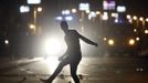 A protester, who opposes Egyptian President Mohamed Mursi, throws stones at riot police, during clashes in front of the presidential palace in Cairo February 11, 2013. Protesters demanding the departure of Egyptian President Mohamed Mursi clashed with police outside his palace on Monday on the second anniversary of the overthrow of veteran autocrat Hosni Mubarak. REUTERS/Amr Abdallah Dalsh (EGYPT - Tags: POLITICS CIVIL UNREST) Published: Úno. 11, 2013, 11:51 odp.