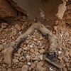 Body of a victim lies trapped in the debris after an earthquake hit, in Kathmandu