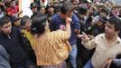 A woman punches a man who was accused of theft in Tactic, in Alta Verapaz region, about 189km (117 miles) from Guatemala City, September 13, 2012. The local community tied up and beat four men who were accused of theft in the aftermath of a school killing, which had occurred on Wednesday. The man, who had entered a classroom and killed two children, ages 8 and 13, with a machete, was lynched and burnt alive by a mob,local media reported. REUTERS/Jorge Dan Lopez (GUATEMALA - Tags: CRIME LAW SOCIETY) Published: Zář. 13, 2012, 6:04 odp.