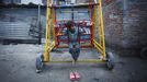 Shivani Choudhary, 7, a street performer rests on a ferris wheel near her hut at the slum on the bank of Manahara River after a whole day of street performance in Kathmandu August 15, 2012. Shivani and her brothers Drumpal and Gchan, who came to Kathmandu from India 5 years ago, earn their living by performing tricks on the streets of Kathmandu. According to Drumpal, Shivani's older brother, they earn around $10 a day by performing tricks, which is not enough to feed their 10-member family living together in a small hut without a proper toilet or any basic needs. REUTERS/Navesh Chitrakar (NEPAL - Tags: SOCIETY POVERTY IMMIGRATION) Published: Srp. 15, 2012, 4:33 odp.