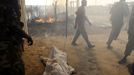 The burnt body of a boy killed during an air strike by the Sudanese air force is covered in sheets in a market in Rubkona