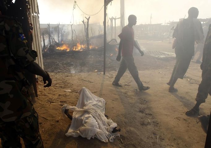 The burnt body of a boy killed during an air strike by the Sudanese air force is covered in sheets in a market in Rubkona