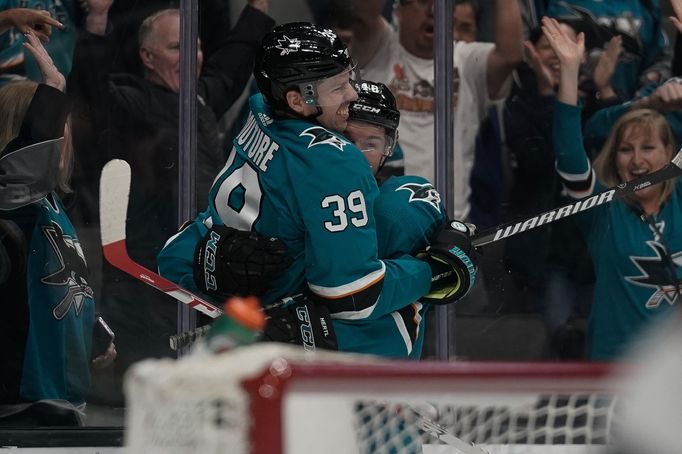 Oct 13, 2019; San Jose, CA, USA; San Jose Sharks center Logan Couture (39) celebrates with center Tomáš Hertl (48) after scoring a goal against the Calgary Flames during