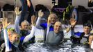 French athlete Philippe Croizon (C), whose arms and legs were amputated after an electric shock accident in March 1994, celebrates with unidentified divers in a 33 metre (36 yard) deep pool, the world's deepest pool built to train professional divers, at Nemo33 diving centre in Brussels January 10, 2013. Croizon, who swam with adapted prostheses that had flippers attached, broke a world record and became the first disabled person to dive to 33 metres, according to the organisers. REUTERS/Yves Herman (BELGIUM - Tags: SPORT DIVING SOCIETY) Published: Led. 10, 2013, 3:40 odp.