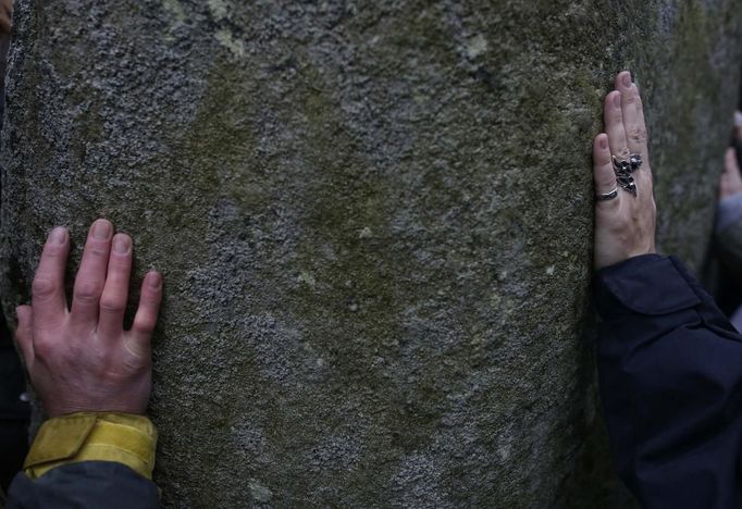 Návštěvníci Stonehenge se dotýkají posvátných kamenů této druidské svatyně pod otevřeným nebem.