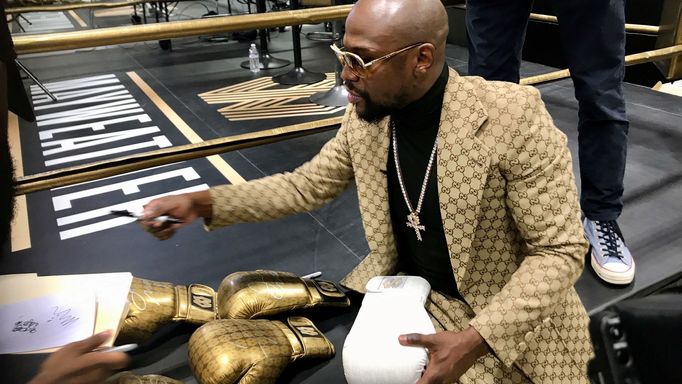 Floyd Mayweather signs gloves at the opening of the Mayweather Boxing + Fitness gym in Torrance, California, U.S., November 16, 2019.  Picture taken November 16, 2019.