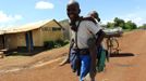 A student from Barack Obama Primary School carries his classmate as they walk from school in Kogelo village, the ancestral home of U.S. President Barack Obama, at Nyangoma Kogelo shopping centre, 430 km (367 miles) west of Kenya's capital Nairobi, November 5, 2012. Four years ago, Kogelo, and Africa in general, celebrated with noisy gusto when Obama, whose father came from the scattered hamlet of tin-roofed homes, became the first African-American to be elected president of the United States. Looking across the Atlantic to the Nov. 6 presidential election, the continent is cooler now towards the "son of Africa" who is seeking a second term. There are questions too whether his Republican rival, Mitt Romney, will have more to offer to sub-Saharan Africa if he wins the White House. To match Analysis AFRICA-USA/ELECTION REUTERS/Thomas Mukoya (KENYA - Tags: EDUCATION SOCIETY ELECTIONS POLITICS USA PRESIDENTIAL ELECTION) Published: Lis. 5, 2012, 11:23 dop.