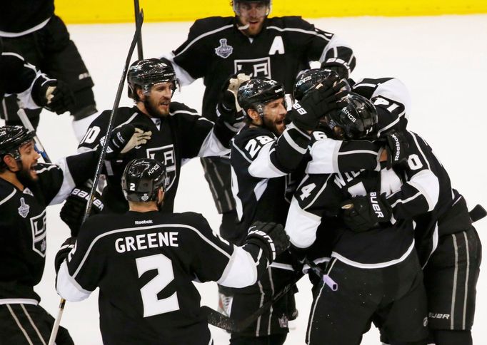 Los Angeles Kings' Justin Williams (14) is congratulated by teammates after scoring the winning goal on the New York Rangers in overtime in Game 1 of their NHL Stanley Cu