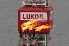 FILE PHOTO: A gas torch is seen next to the Lukoil company sign at the Filanovskogo oil platform in the Caspian Sea, Russia October 16, 2018. REUTERS/Maxim Shemetov//File