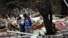 Vicente Gabarri Valdes tries to console his nephew Saul as he stands amidst the remains of his home after it was demolished at the Spanish gypsy settlement of Puerta de Hierro, in the outskirts of Madrid November 20, 2012. Fifty-four families have been living in Puerta de Hierro, on the banks of the Manzanares river for over 50 years. Since the summer of 2010, the community has been subject to evictions on the grounds that the dwellings are illegal. Families, whose homes have been demolished, move in with relatives whose houses still remain while the debris keeps piling up around them as more demolitions take place. REUTERS/Susana Vera (SPAIN - Tags: CIVIL UNREST BUSINESS CONSTRUCTION) Published: Lis. 20, 2012, 4:52 odp.