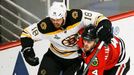 Boston Bruins' Nathan Horton (L) tries to get around Chicago Blackhawks' Niklas Hjalmarsson during the second period in Game 2 of their NHL Stanley Cup Finals hockey seri