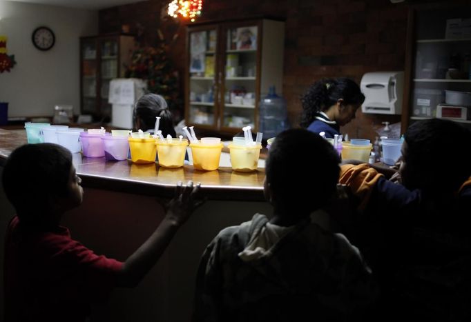 REFILE - CORRECTING GRAMMAR IN FIRST SENTENCE Children wait to take their medication in the San Jose Hospice, in Sacatepequez, 45 km (28 miles) from Guatemala City, November 30, 2012. About 68 HIV-infected children receive free medical care at the hospice, many of them were found abandoned in markets, churches, fire stations, left neglected in hospitals or in some instances, brought in by their families who cannot afford to pay for their medical treatment. World AIDS Day which falls on December 1 is commemorated across the world to raise awareness of the pandemic. REUTERS/Jorge Dan Lopez (GUATEMALA - Tags: ANNIVERSARY HEALTH) Published: Pro. 1, 2012, 6:59 dop.