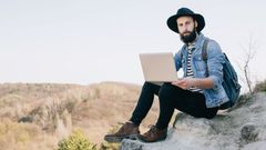 hipster s notebookem na dovolené na výletě v přírodě