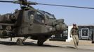 Britain's Prince Harry (C partially obscured) sits in the cockpit of an Apache helicopter in Camp Bastion, southern Afghanistan in this photograph taken November 1, 2012, and released January 21, 2013. The Prince, who is serving as a pilot/gunner with 662 Squadron Army Air Corps, is on a posting to Afghanistan that runs from September 2012 to January 2013. Photograph taken November 1, 2012. Photograph pixelated at source. REUTERS/John Stillwell/Pool (AFGHANISTAN - Tags: MILITARY POLITICS SOCIETY ROYALS CONFLICT) Published: Led. 21, 2013, 8:02 odp.