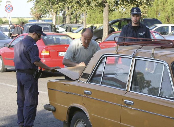 Security personnel check a passenger's car outside Bulgaria's Burgas airport July 18, 2012. An explosion which killed six people and injured dozens of Israeli tourists at the Bulgarian airport of Burgas was caused by a bomb in their bus, Bulgarian Foreign Minister Nikolai Mladenov told Reuters by telephone. In a statement, the foreign ministry said five people were killed and one died later in hospital. Thirty two people were taken to hospital with injuries. REUTERS/Impact Press Group (BULGARIA - Tags: DISASTER TRANSPORT)