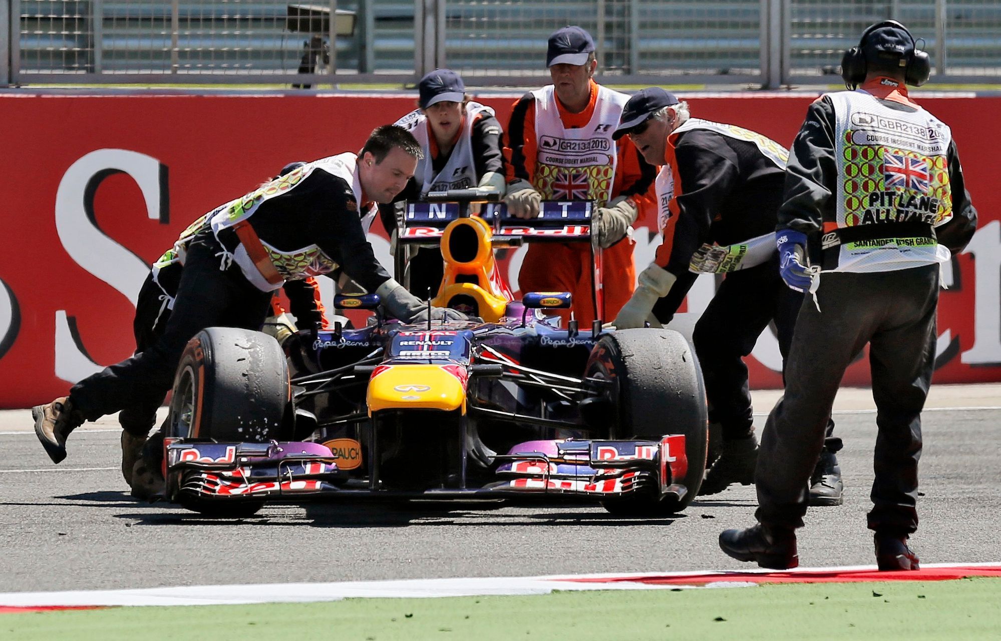 Marshalls remove abandoned car of Red Bull Formula One drive