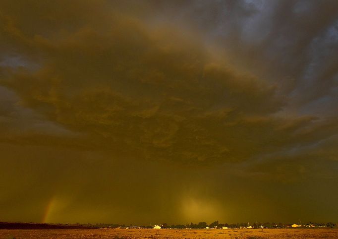 A dust storm hovers over Queen Creek, Ariz. Thursday, Aug. 18, 2011. The dust storm, also known as a haboob in Arabic and around Arizona, swept through Pinal County and headed northeast, reaching Phoenix at about 6 p.m. It was the third major dust storm to hit the Phoenix metro area since last month. (AP Photo/Matt York)