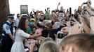 Catherine, the Duchess of Cambridge, greets a crowd gathered near a surf lifesaving demonstration at Sydney's Manly beach