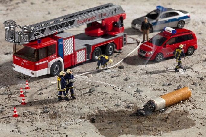 Miniature figurines of firemen using a hose to put out a smoking cigarette butt Image: 0129612167, License: Royalty free, Restrictions: Not available for license to or for use in the following territories: Argentina, Brazil, Chile, Costa Rica, Ecuador, Japan, Mexico, Peru, Spain, Uruguay and Venezuela. For multi-territory license please contact your Corbis Account Representative. Not available for use in Corbis Merchandise., Property Release: No or not aplicable, Model Release: No or not aplicable, Credit line: Profimedia.cz, Corbis