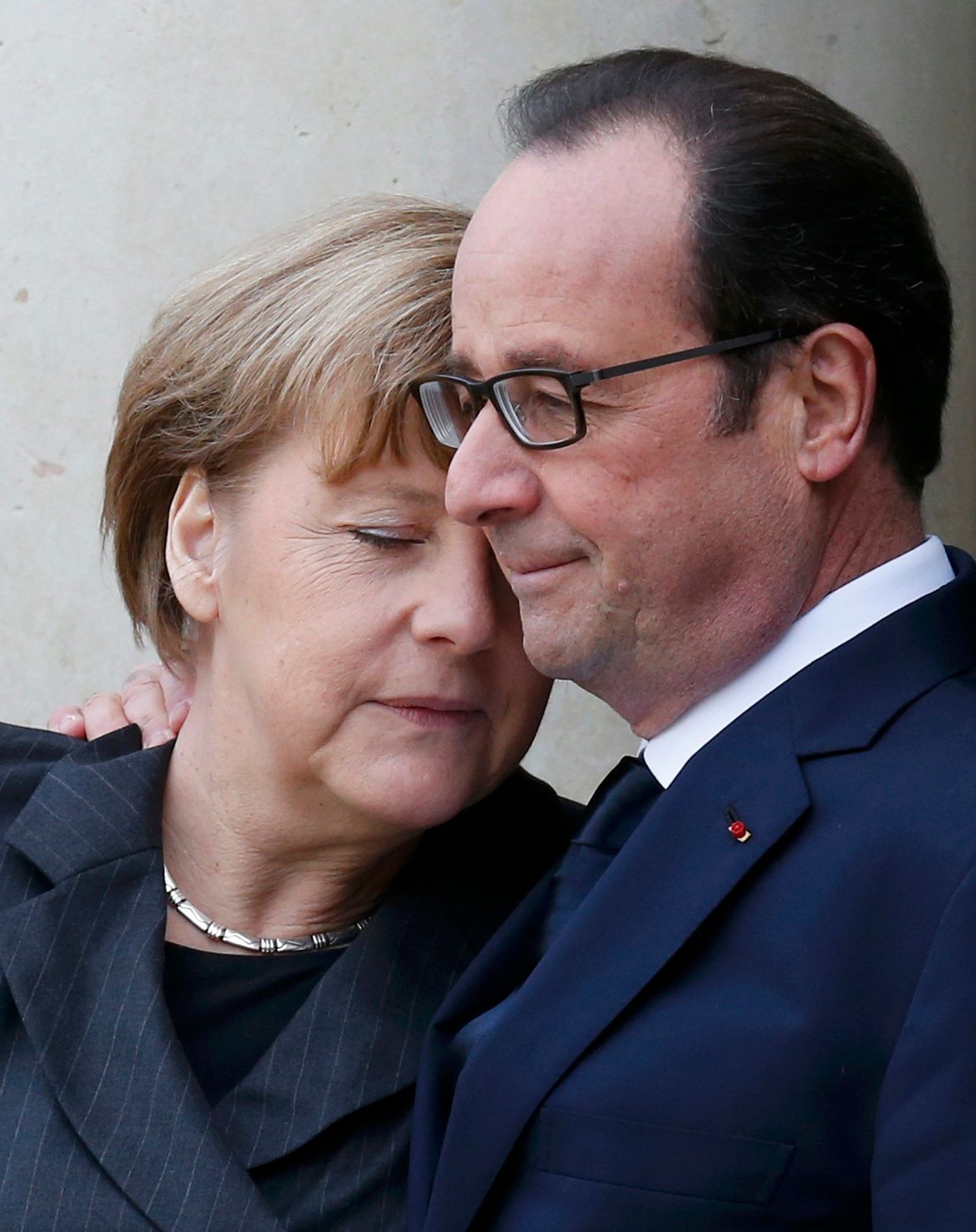 French President Hollande welcomes Germany's Chancellor Merkel as she arrives at the Elysee Palace before the solidarity marchin the streets of Paris