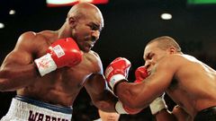 FILE PHOTO: WBA Heavyweight Champion Evander Holyfield (R) connects to the jaw of challenger Mike Tyson in the f..